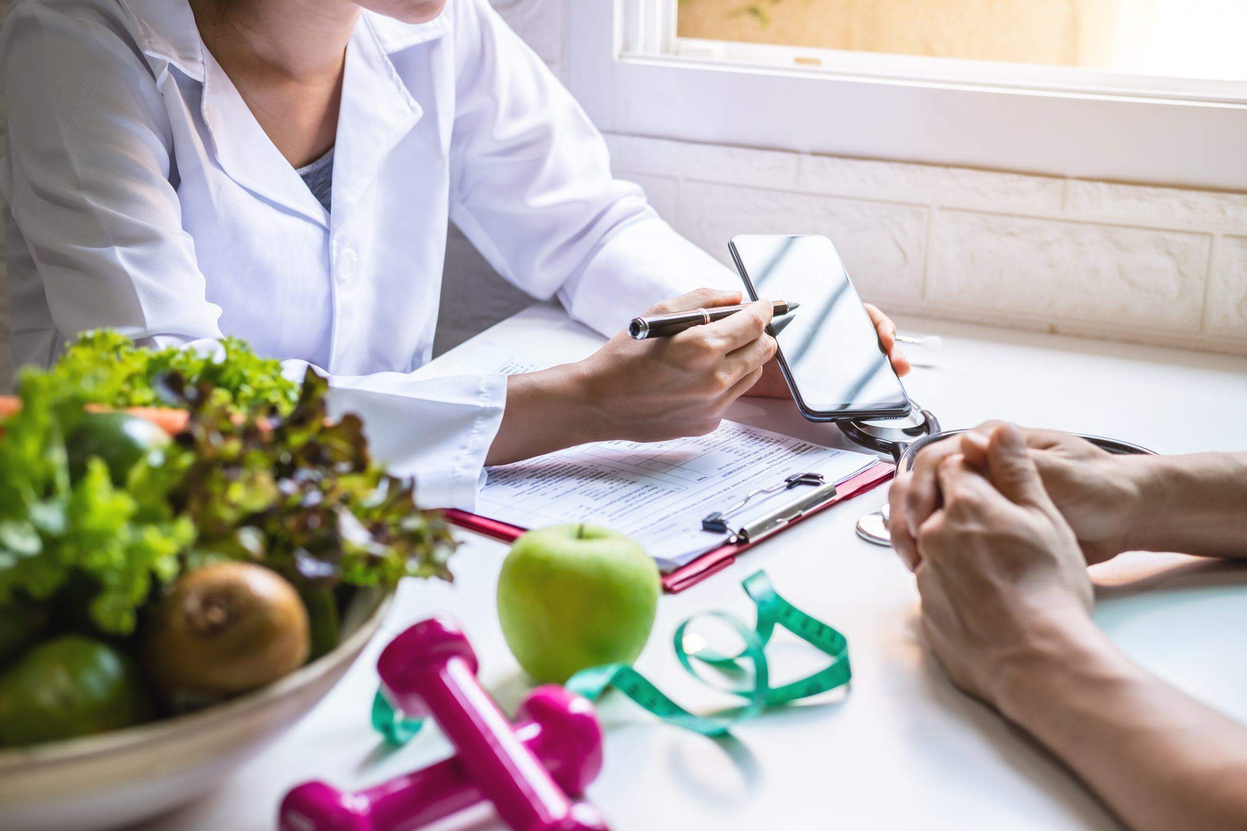 A Nutritionist at the Clinic Giving Diet Tips to Patient for Weight Control in Visalia, CA