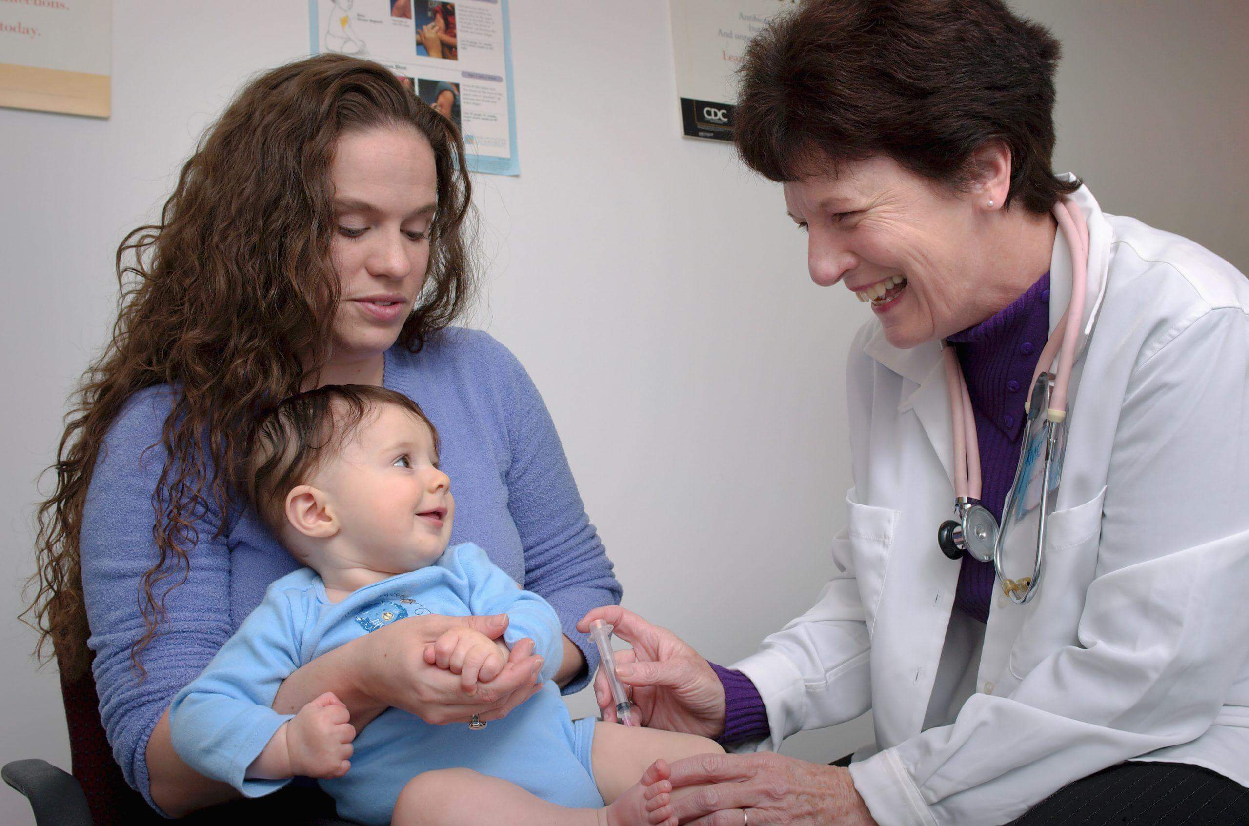 Doctor gives immunization to baby