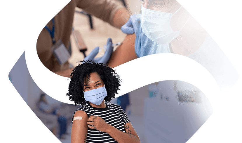 A woman showing her vaccine shot with the background of the FHCN logo